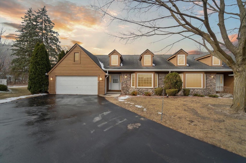 new england style home featuring a garage