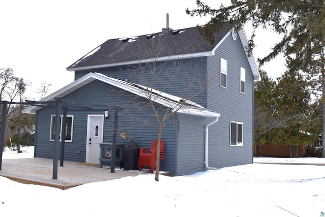 snow covered property featuring a deck