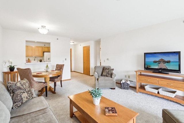 living room with sink and light carpet