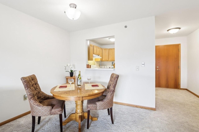 dining room with light colored carpet