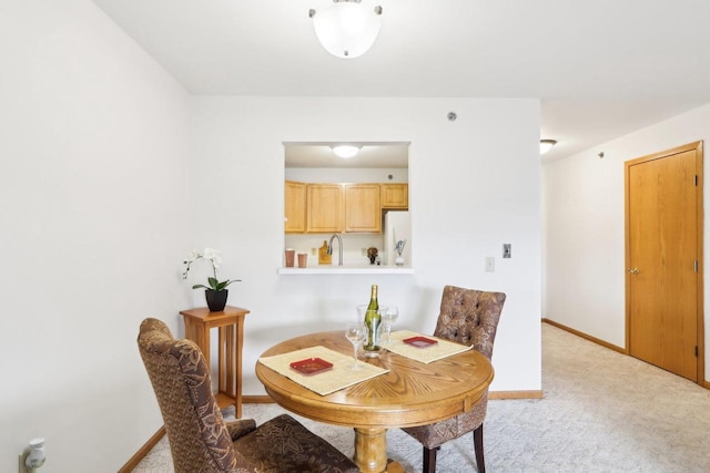 dining area with light colored carpet