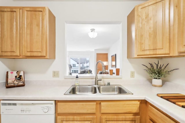 kitchen featuring white dishwasher, sink, and light brown cabinets