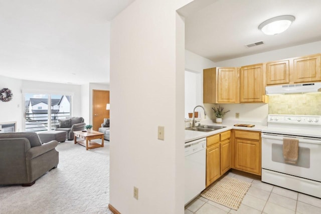 kitchen with sink, light brown cabinets, light tile patterned floors, white appliances, and decorative backsplash