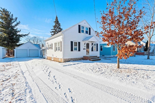 view of front of property featuring a garage and an outbuilding