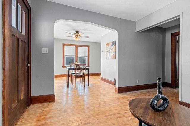 entrance foyer with ceiling fan and light hardwood / wood-style flooring