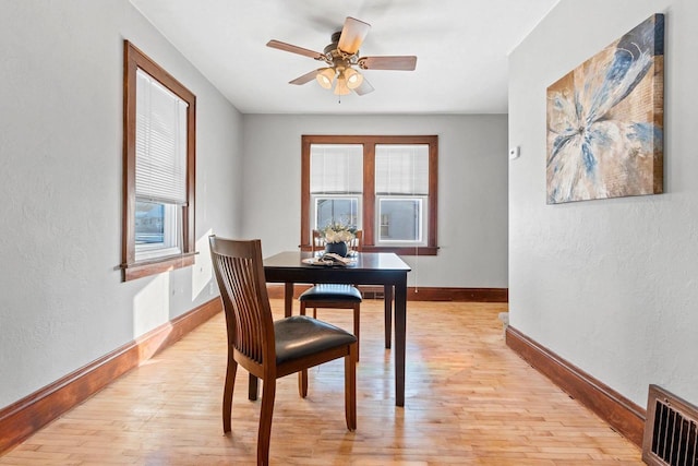 dining space featuring ceiling fan and light hardwood / wood-style flooring