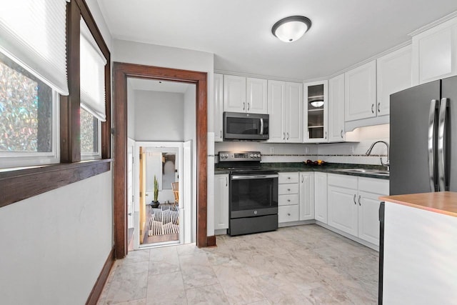 kitchen with white cabinetry, sink, and appliances with stainless steel finishes