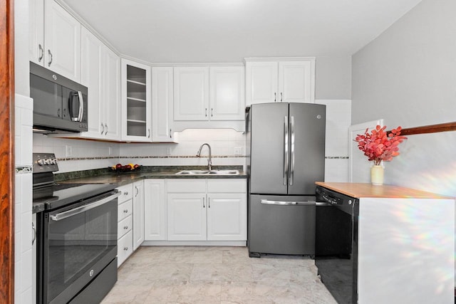 kitchen featuring stainless steel refrigerator, white cabinetry, sink, and electric range