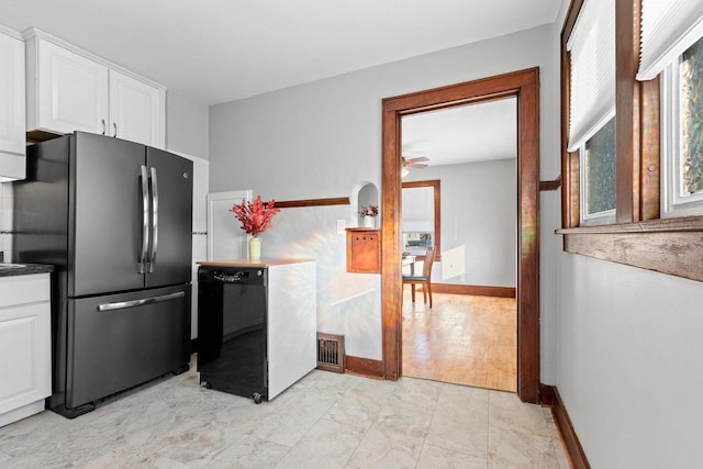 kitchen featuring white cabinetry, black dishwasher, ceiling fan, and stainless steel refrigerator