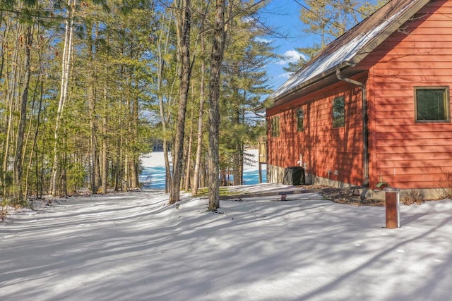 snowy yard with a water view