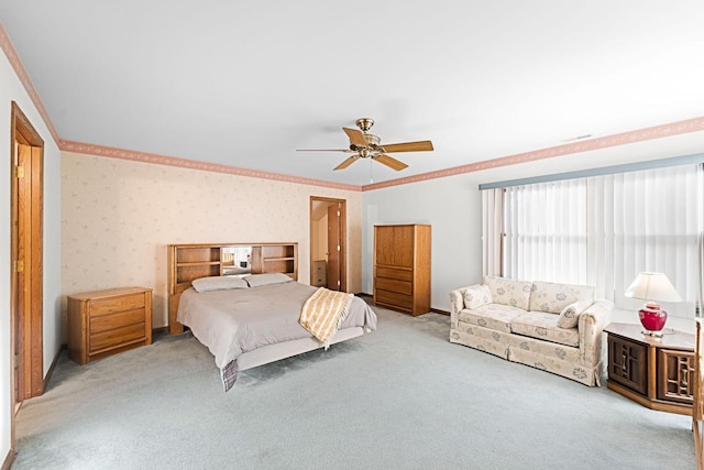 carpeted bedroom with crown molding and ceiling fan