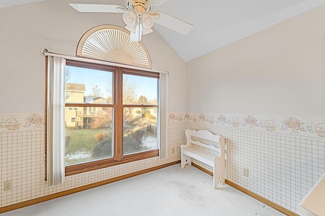 interior space with ceiling fan and carpet