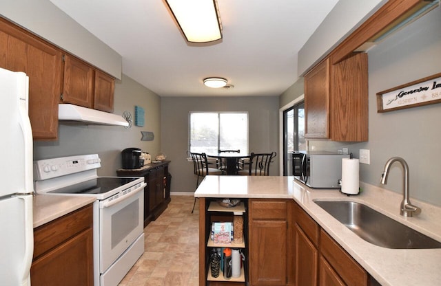 kitchen featuring sink and white appliances