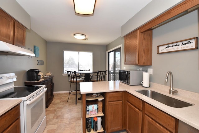 kitchen with white electric stove and sink