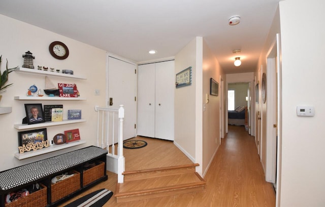 hallway with light hardwood / wood-style flooring