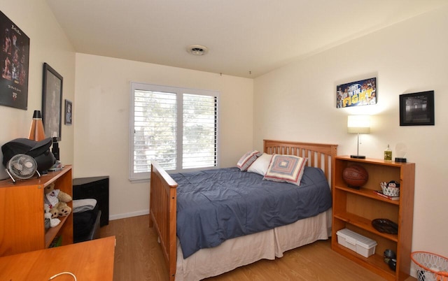 bedroom with hardwood / wood-style flooring