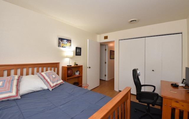 bedroom with light wood-type flooring and a closet