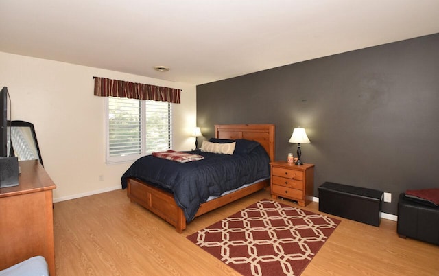 bedroom with hardwood / wood-style flooring