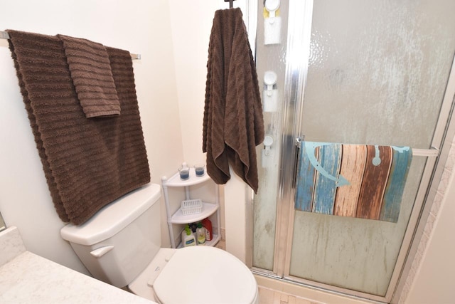 bathroom featuring an enclosed shower and toilet