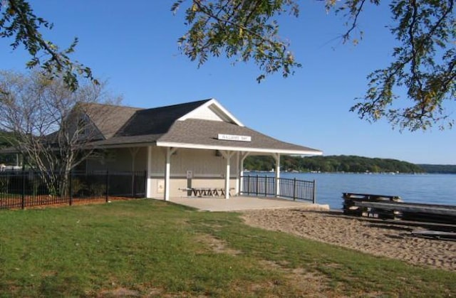 dock area featuring a lawn and a water view