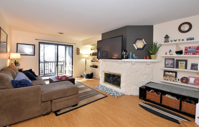 living room featuring hardwood / wood-style flooring and a high end fireplace