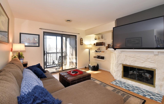 living room featuring wood-type flooring and a high end fireplace