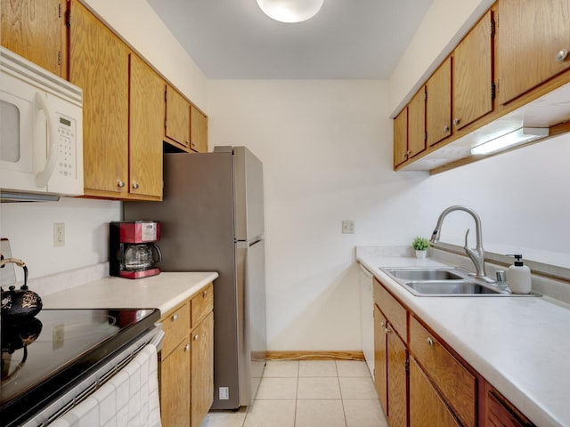 kitchen with stainless steel electric stove, sink, and light tile patterned floors