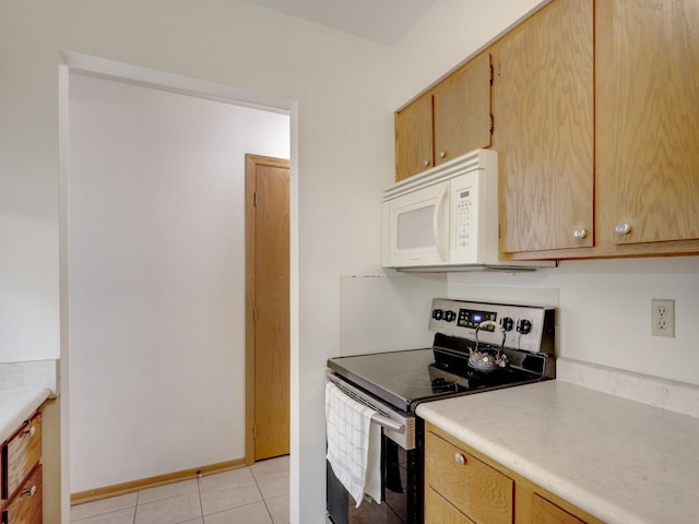 kitchen with stainless steel range with electric stovetop and light tile patterned floors