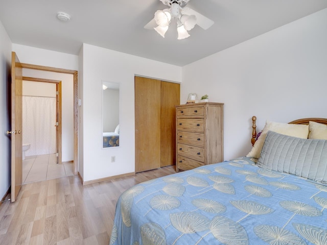 bedroom with ceiling fan, light hardwood / wood-style floors, and a closet