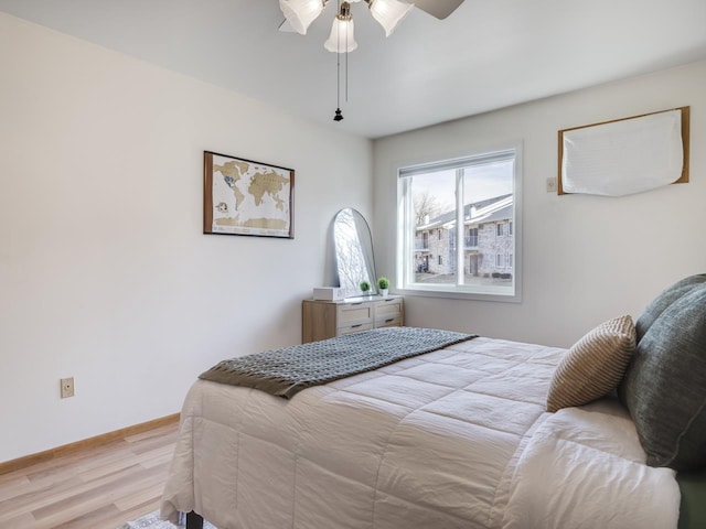 bedroom with ceiling fan and light hardwood / wood-style floors