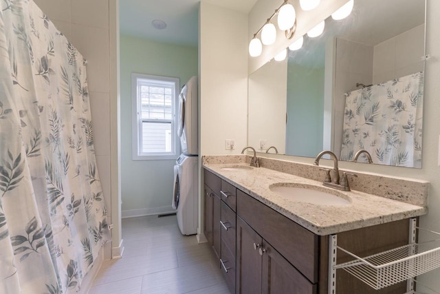 bathroom with vanity, a shower with shower curtain, and stacked washer / dryer