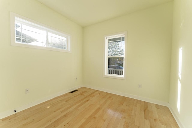 empty room with light hardwood / wood-style flooring