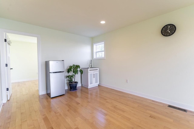 empty room featuring sink and light wood-type flooring