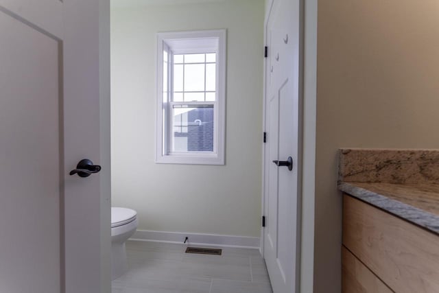 bathroom with tile patterned floors and toilet