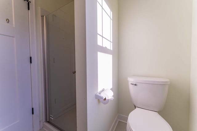 bathroom with toilet and walk in shower