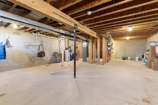 basement featuring water heater and sink