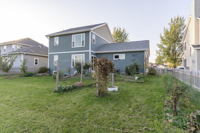 rear view of house with a yard