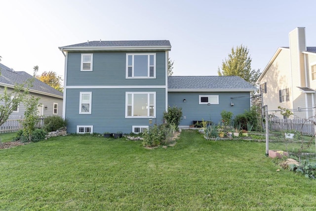 rear view of property featuring a lawn