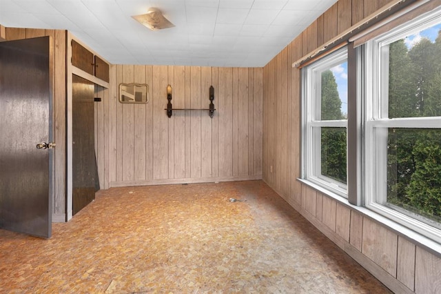 empty room featuring wooden walls