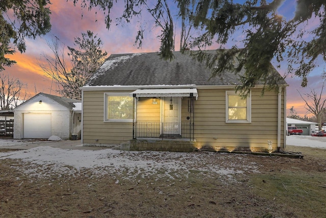 view of front of house with a garage and an outdoor structure