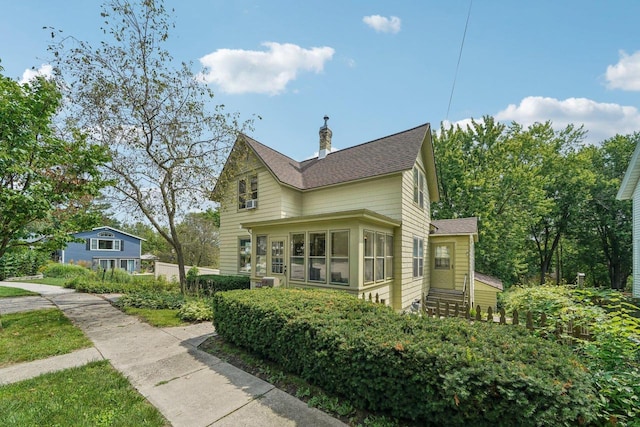 view of side of home featuring a sunroom