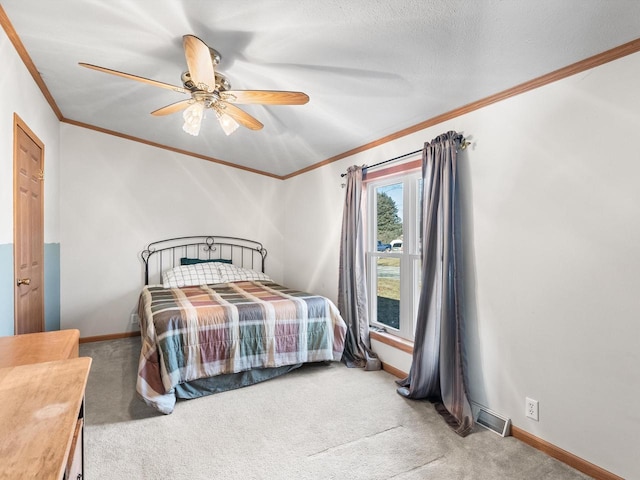 bedroom featuring ornamental molding, carpet flooring, a textured ceiling, and ceiling fan