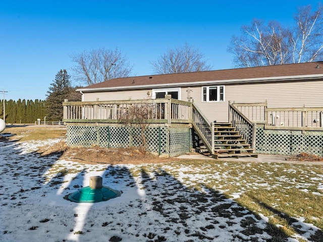 snow covered property featuring a wooden deck