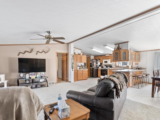 living room featuring crown molding, ceiling fan, and lofted ceiling