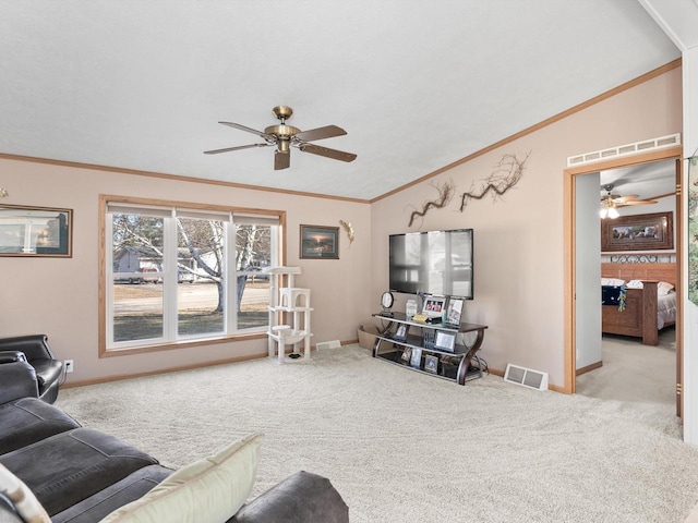 living room featuring light carpet, crown molding, lofted ceiling, and ceiling fan