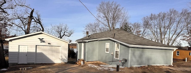 exterior space featuring an outbuilding and a garage