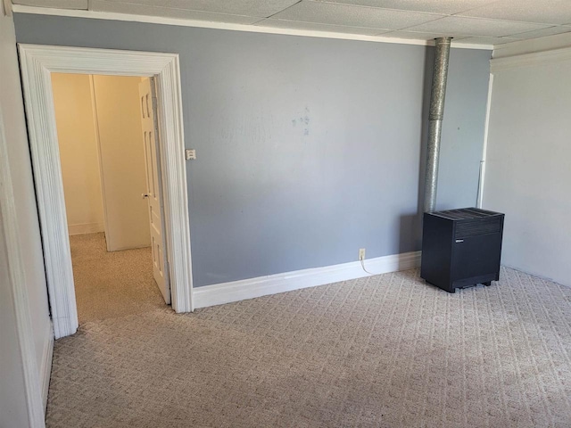 interior space featuring a paneled ceiling and light colored carpet