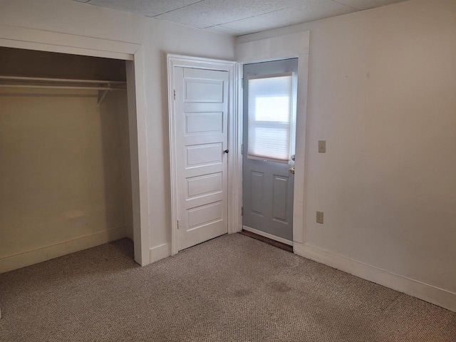 unfurnished bedroom with a closet and carpet flooring