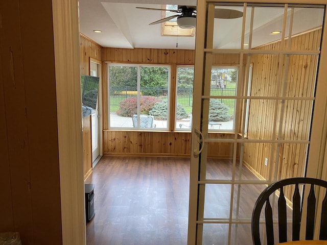 unfurnished sunroom featuring ceiling fan