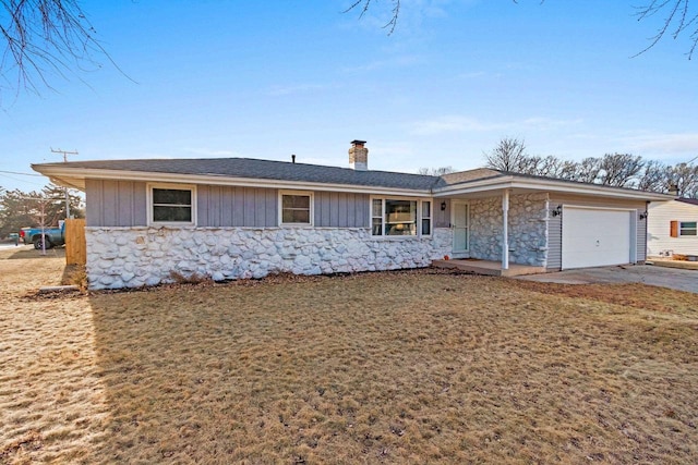 ranch-style home with a garage and a front yard